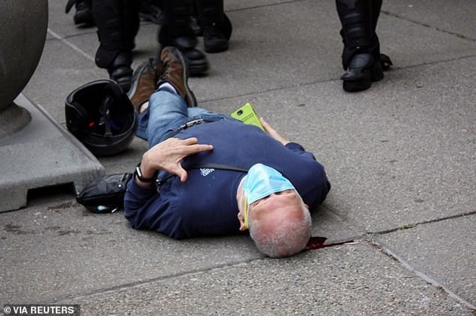 The 75-year-old longtime peace activist who suffered a brain injury after he was pushed to the ground by Buffalo cops during a Black Lives Matter protest (pictured) will not return home on his release from hospital because 'concerning and threatening messages and one letter' sent to him have sparked fears over his safety, lawyer Kelly Zarcone said Thursday