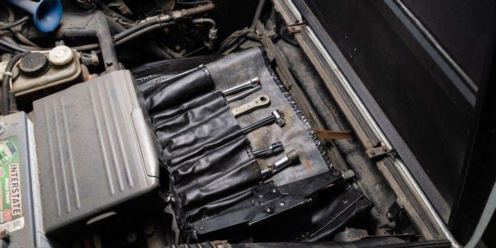 The car is being sold with its factory tool kit.