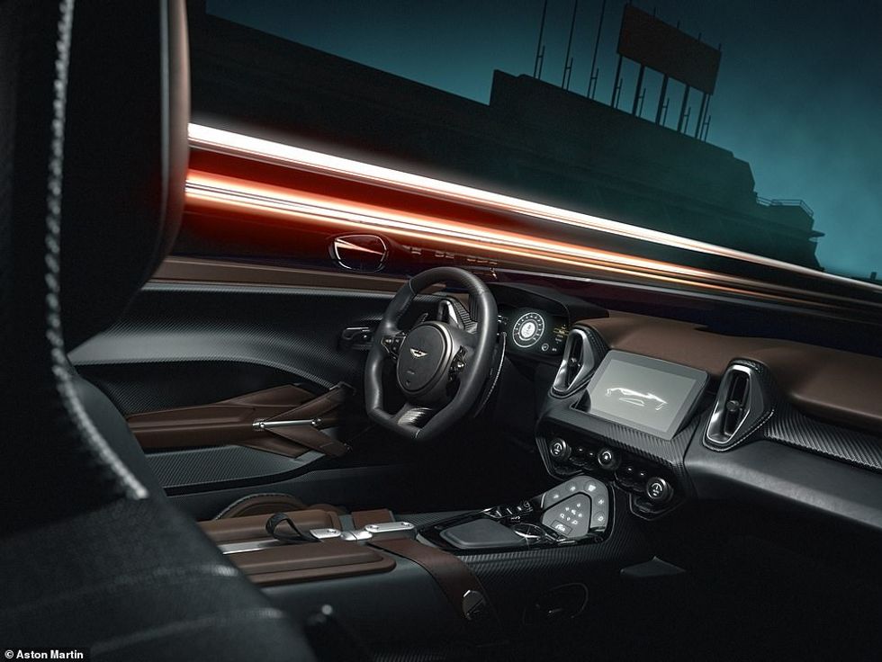 The DBR22s cockpit features extensive use of both leather and exposed carbon fibre, with an uncluttered dashboard and sleek infotainment display