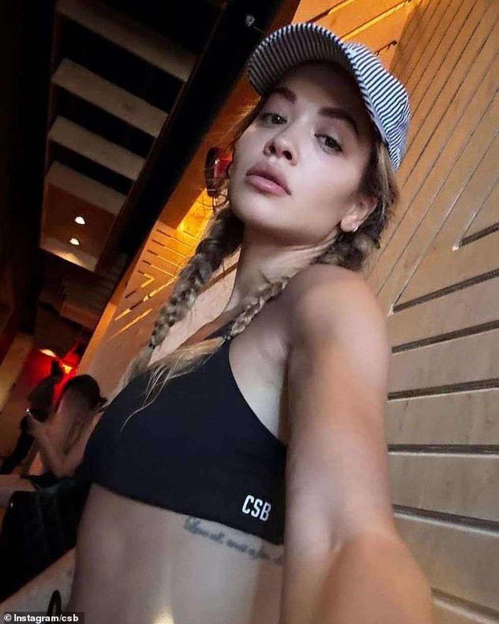 The fitness fanatic put her washboard abs on display in a black bralet and matching drawstring bike shorts from Crop Shop Boutique, with the set costing around $118