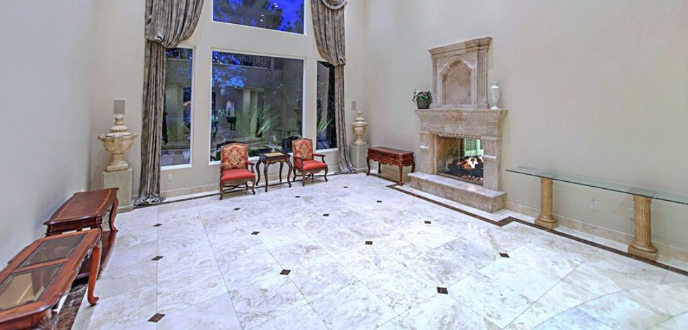 The formal living room with a stone fireplace.