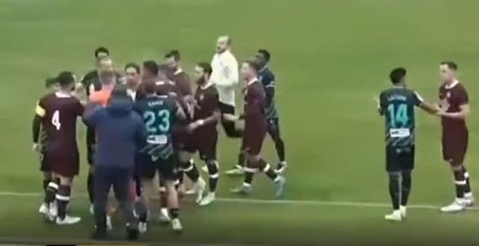 The match was subsequently abandoned after players and coaches all ran onto the field