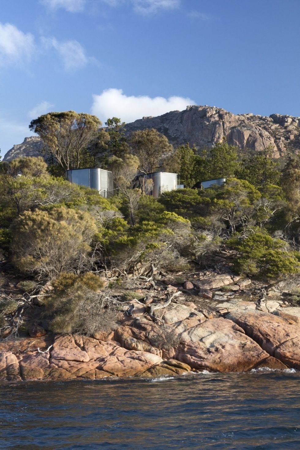 the nine pavilions are perched atop the beautiful weathered pink granite of the freycinet p