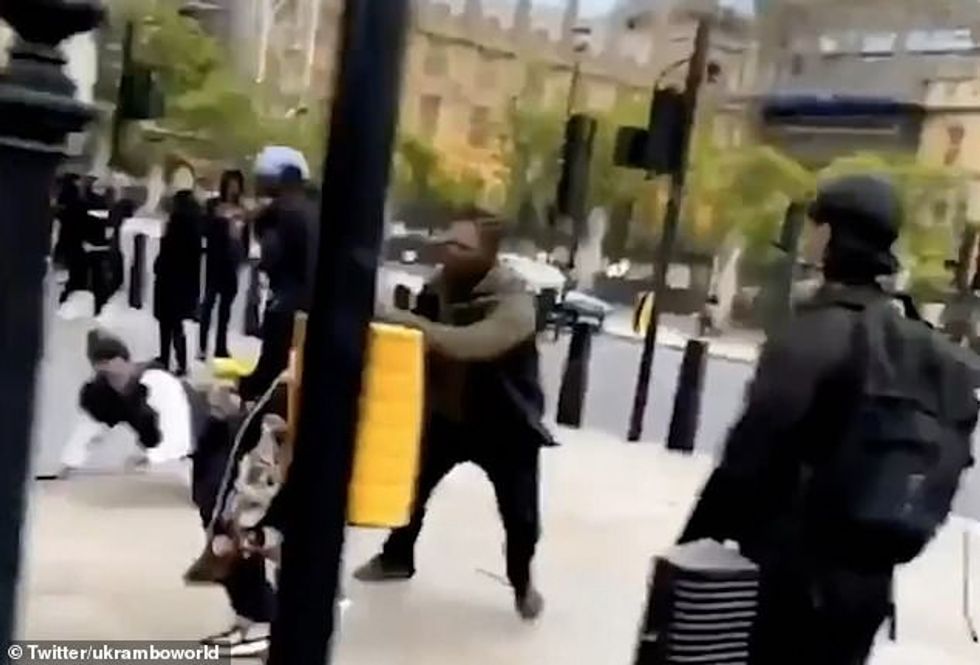 The officer quickly scrambles to pick up his hat which is knocked off during his fall and clambers back onto his feet