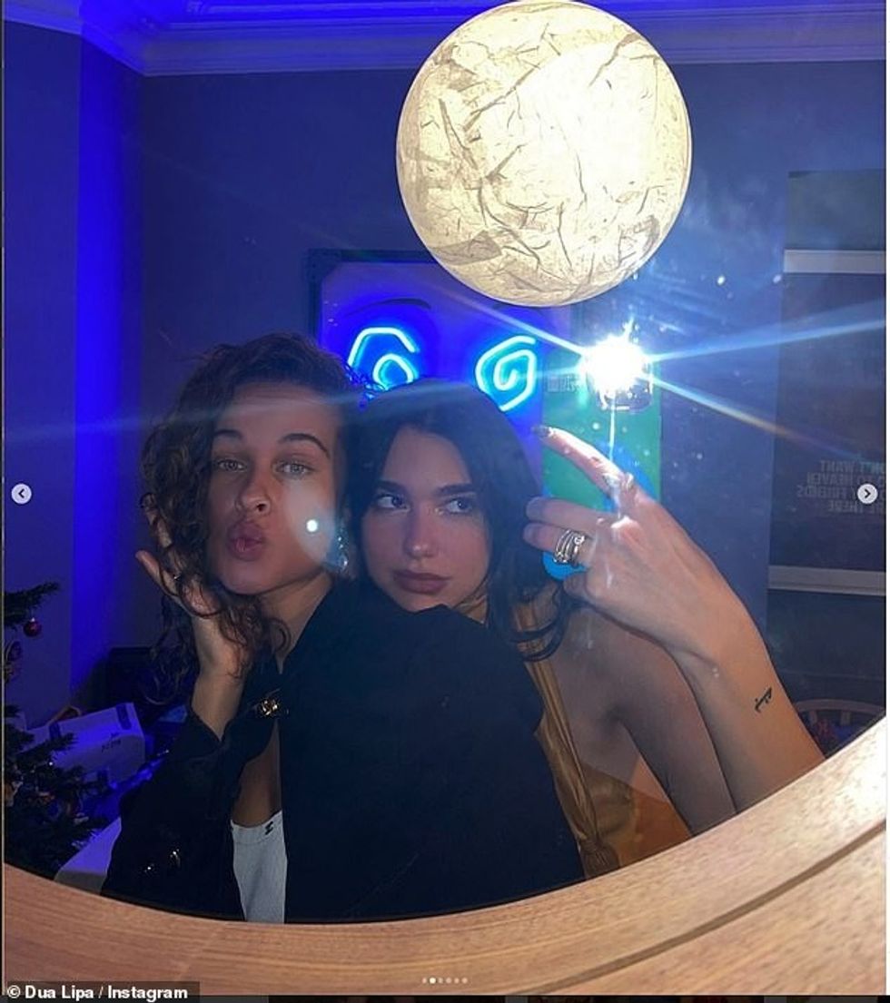 The singer posed for a snap in what appeared to be her living room with graphic neon lighting artwork and a wooden mirror