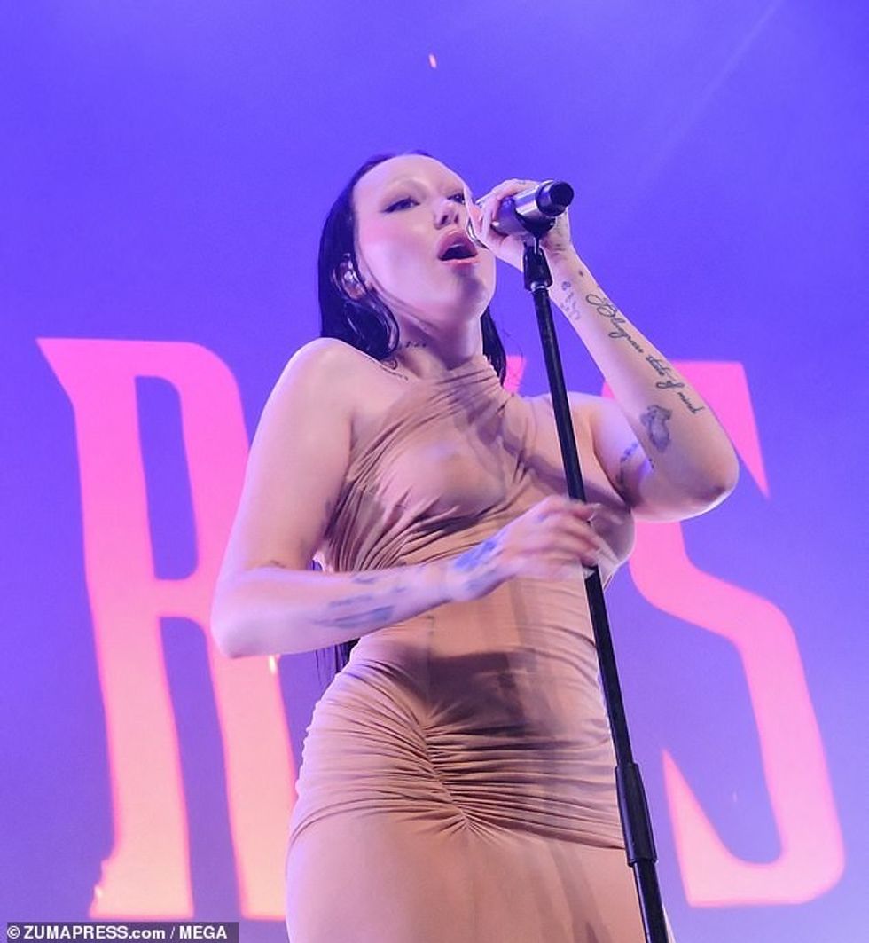 The single shoulder, ruched gown made Noah appear nude as she frolicked around the stage parading around her figure confidently