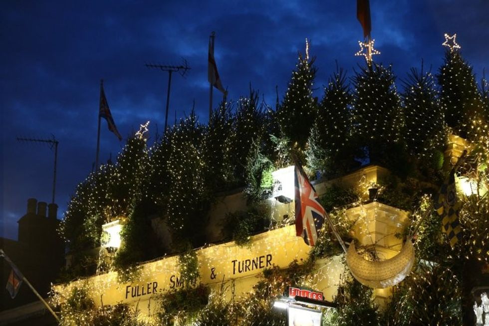 The stunning Churchill Arms pub in Kensington, London which is lit up with 85 Christmas trees, December 7 2016. The famous pub, near to Notting Hill Gate, has used flowers and plants all year round attract punters for nearly 30 years.
