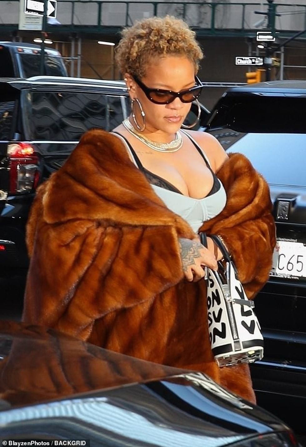 The Umbrella music artist accessorized with supersize hoop earrings