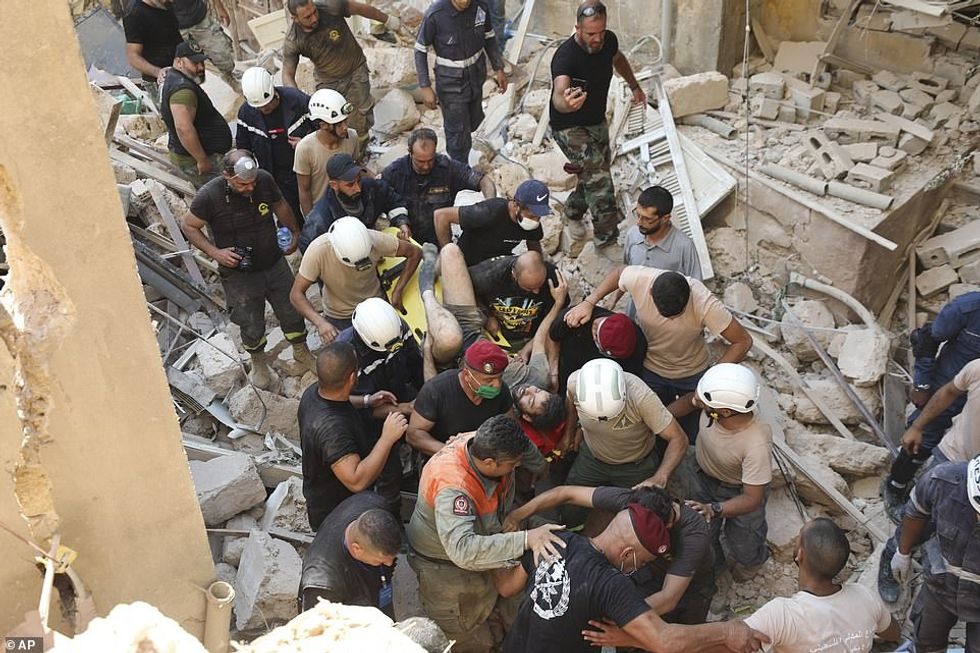 This is the moment a man - named only as Issam - was pulled alive from the ruins of a destroyed apartment block in central Beirut on Wednesday, 10 hours after the city was hit by a massive explosion