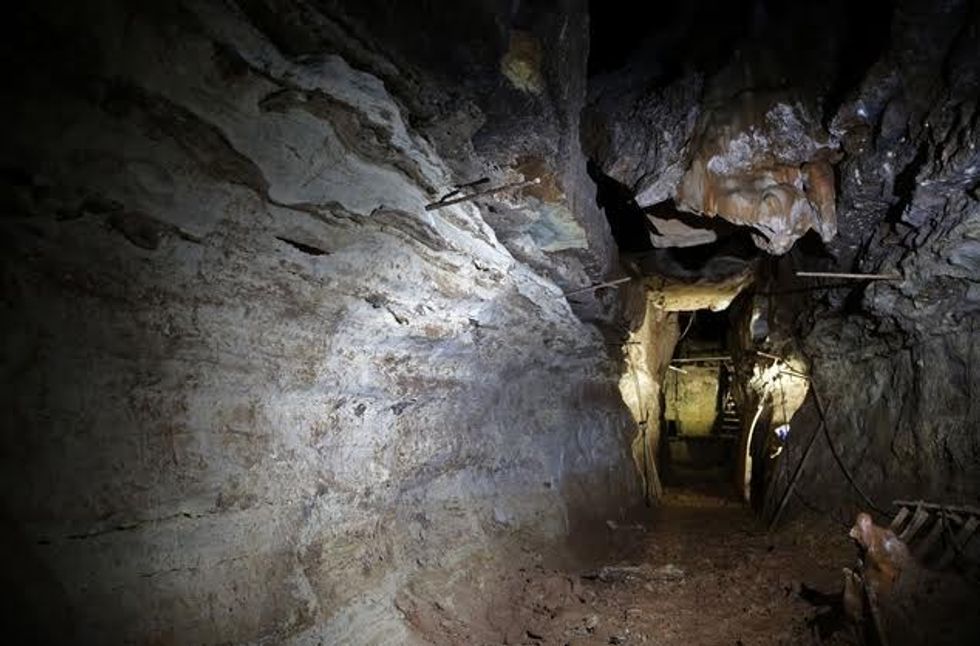 This photo made Thursday, April 14, 2016, shows a cave discovered in 1993 by Bass Pro Shops founder Johnny Morris in Ridgedale, Mo. Morris believes the cave could be part of a larger unknown system after water from a sinkhole on his golf course about a half-mile away began flowing out the entrance. (AP Photo/Jeff Roberson)