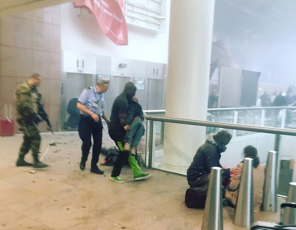 This photo provided by Georgian Public Broadcaster and photographed by Ketevan Kardava, shows the scene in Brussels Airport in Brussels, Belgium, after explosions were heard Tuesday, March 22, 2016. A developing situation left a number dead in explosions that ripped through the departure hall at Brussels airport Tuesday, police said. All flights were canceled, arriving planes were being diverted and Belgium's terror alert level was raised to maximum, officials said. (Ketevan Kardava/ Georgian Public Broadcaster via AP)