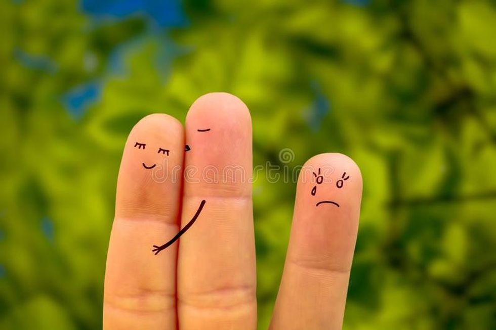 three people two women one man man cheats his girlfriend man hugs kisses another woman betrayal affection kiss 108819729