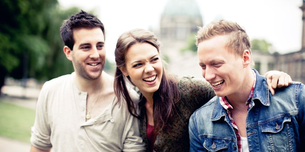 Three young adults talking and laughing