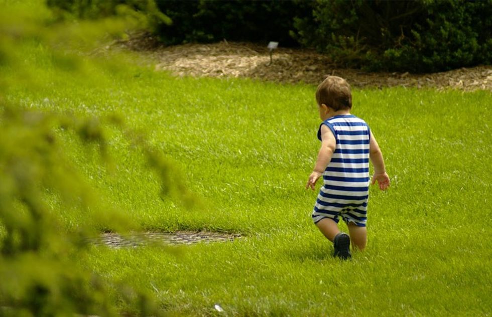 toddler playing in lawn
