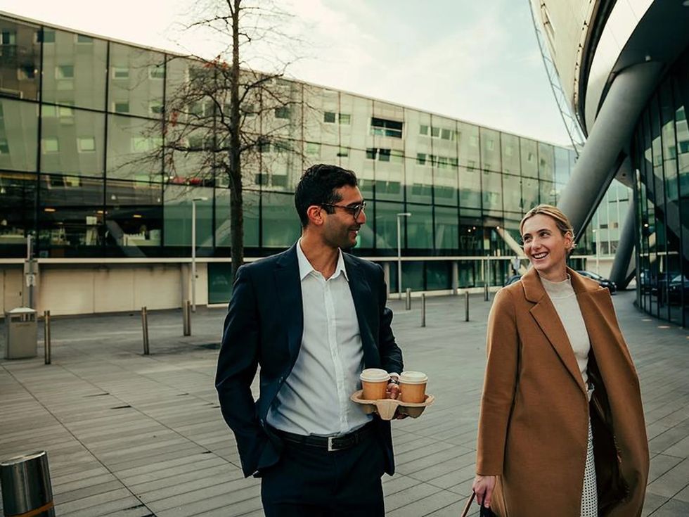 two coworkers go for a walk at work