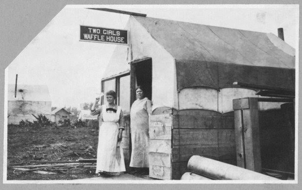 Two women stand outside the Two Girls Waffle House, circa 1900-1916, in this Library of Congress handout photo. For women 100 years ago, opportunities to work beyond the home and take part in political life were very limited. As the 20th century progressed, hard-won progress included gradually improved voting rights, while the upheaval of war pushed doors ajar as women worked as part of the war effort. U.S. Library of Congress archive photos show women's workplaces ranging from a flour mill in England to a coal mine in Belgium or Lincoln Motor Co.'s welding department in Detroit. International Women's Day is celebrated on March 8. REUTERS/Carpenter Collection/Library of Congress/Handout via Reuters SEARCH