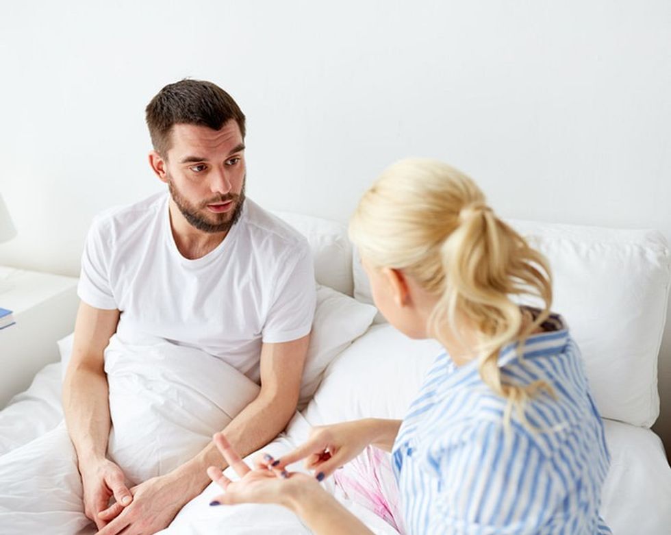 unhappy couple having an argument in their bedroom free photo