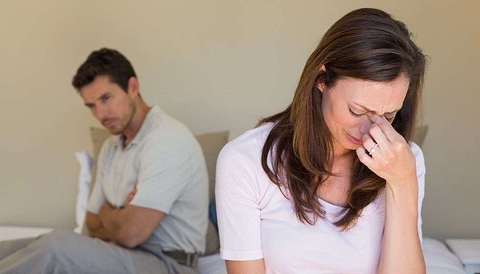 Unhappy couple not talking after an argument in bed at home