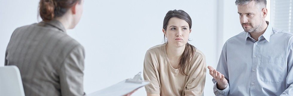 unhappy couple talking to divorce mediator