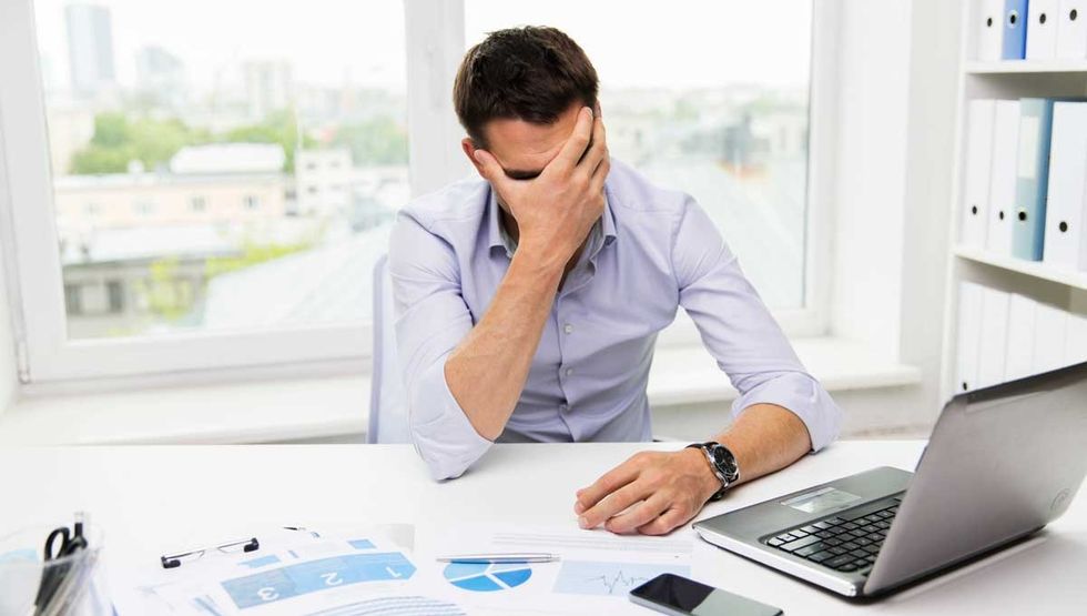 unhappy man work facepalm