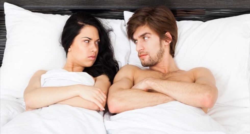 Unhappy-Separate-Couple-Lying-In-A-Bed-Shutterstock-