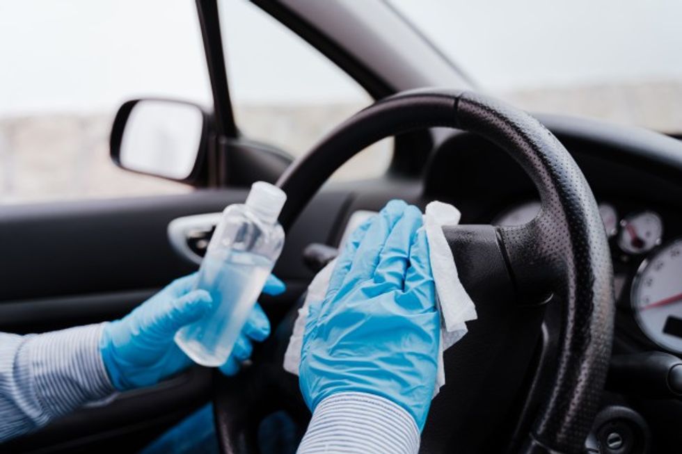unrecognizable man car using alcohol gel disinfect steering wheel during pandemic 139317 5249