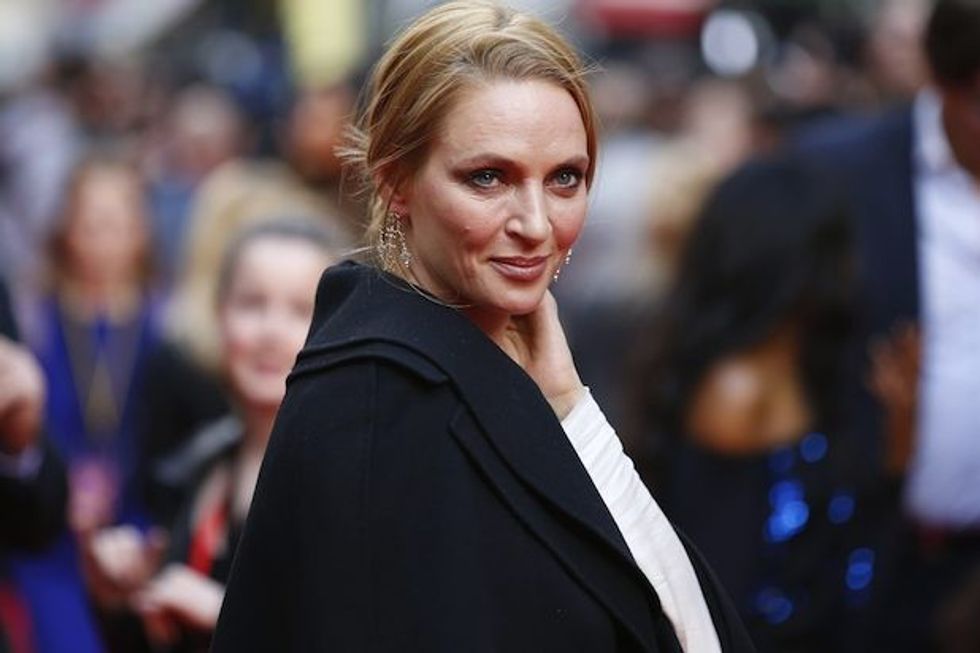 US actress Uma Thurman poses for photographers while arriving for the Premiere of West End musical Charlie and the Chocolate Factory, at the Theatre Royal, in central London on June 25, 2013. AFP PHOTO / JUSTIN TALLIS (Photo credit should read JUSTIN TALLIS/AFP/Getty Images)