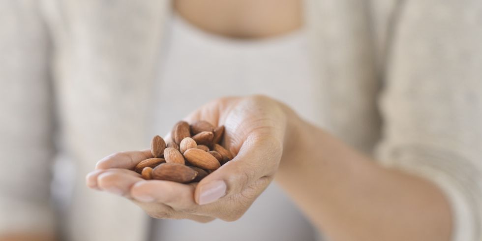 USA, New Jersey, Jersey City, Close-up of woman holding almonds
