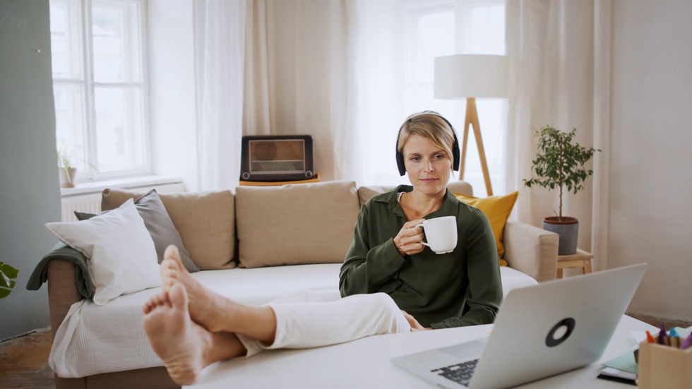 videoblocks portrait of happy business woman indoors in office sitting at desk listening to