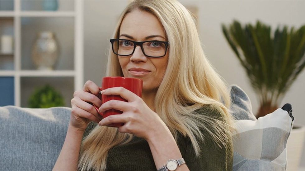 videoblocks portrait shot of the pretty blonde woman in glasses drin