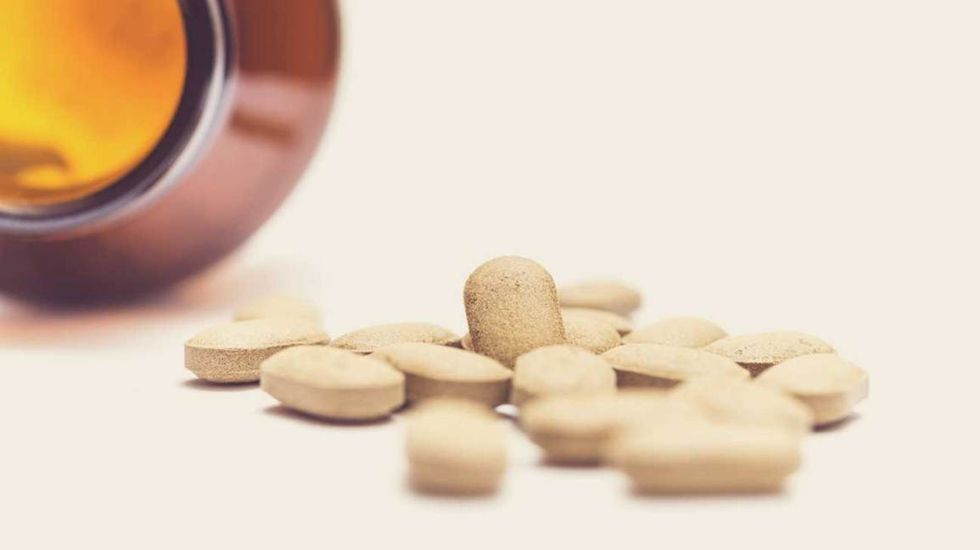 vitamins spilling out of bottle 1