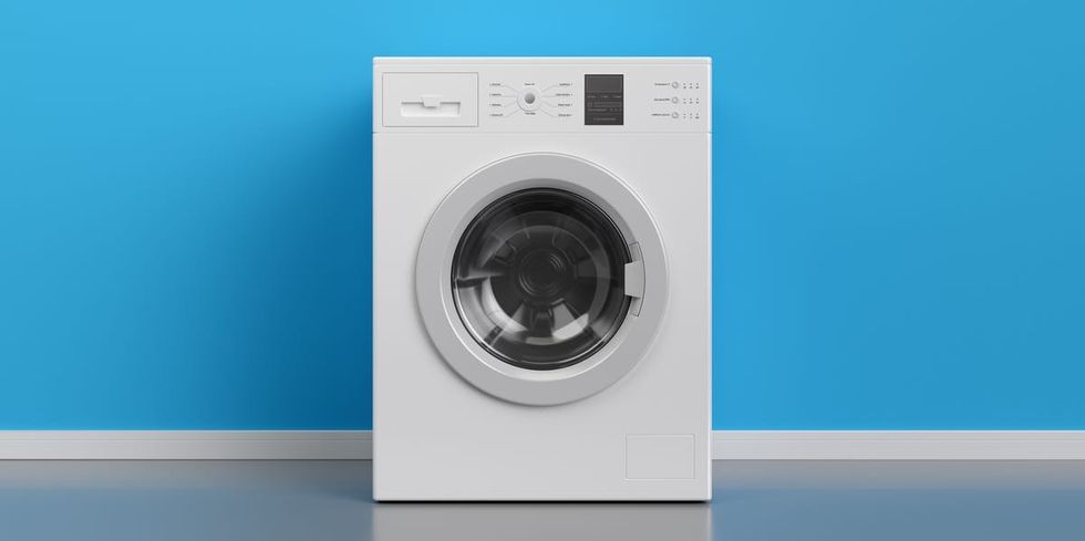 washing machine at blue wall frontal view with copy royalty free image 1096523200 1564593294