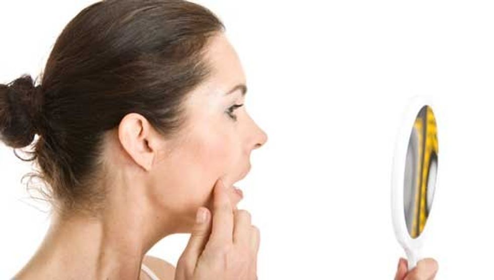 woman acne mirror