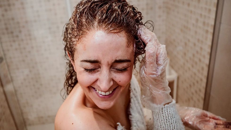 Woman applying hair treatment header