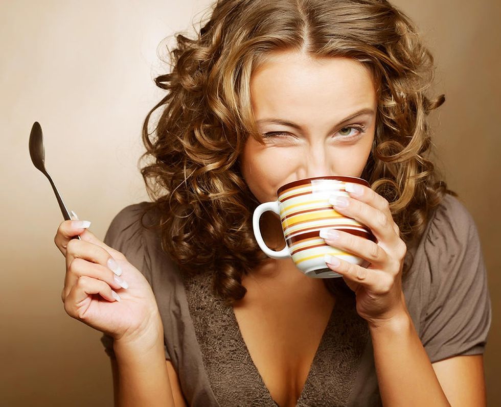 woman drinking coffee and winking