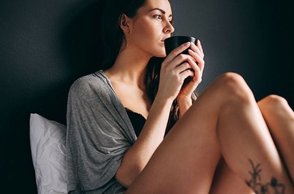 woman drinking tea in bed