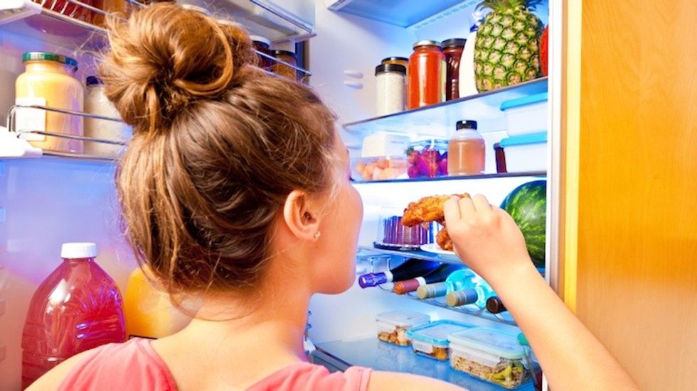woman eating from fridge 11 reasons youre always hungry by healthista