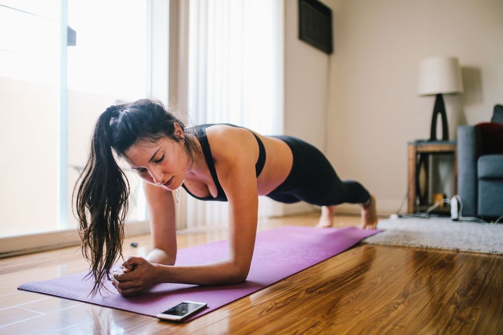woman exercising planks at home in los angeles royalty free image 1587667600