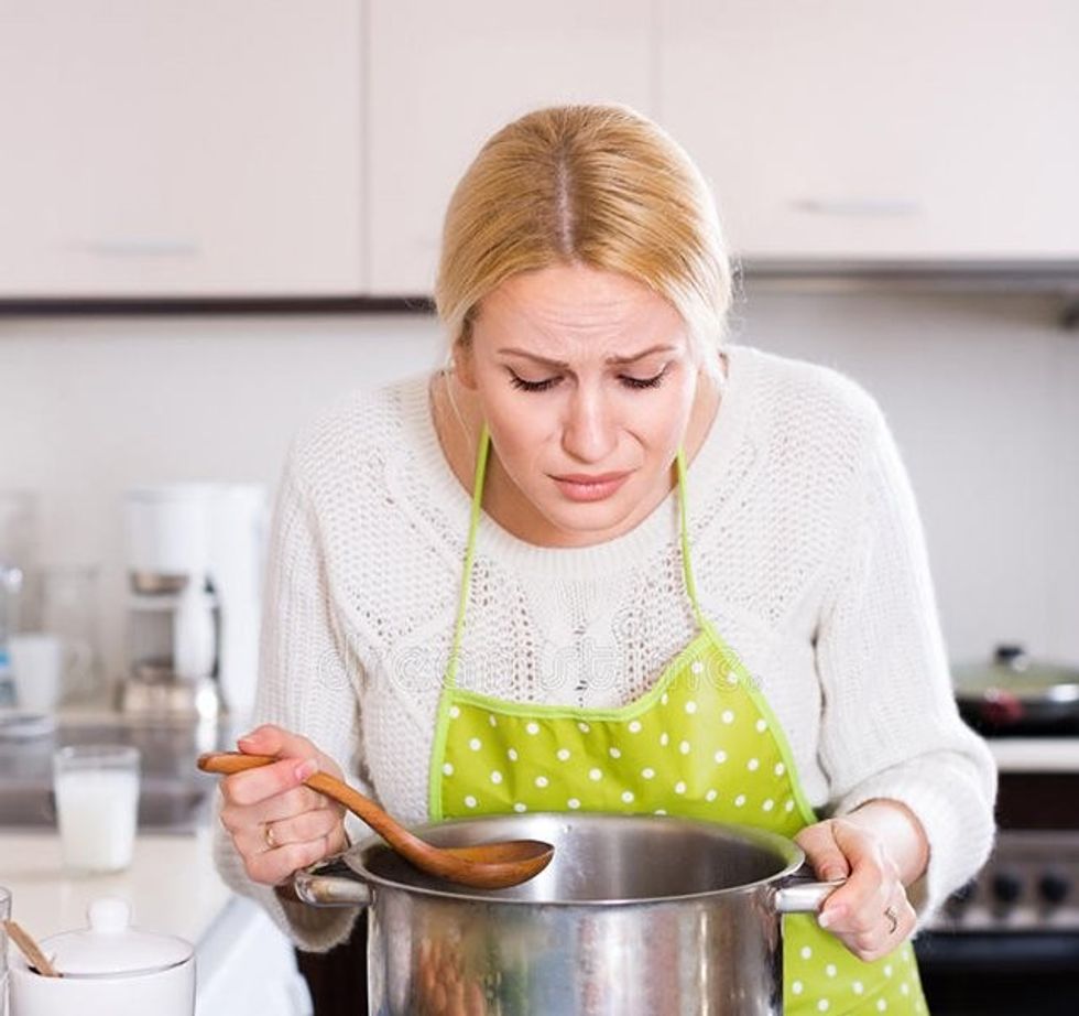 woman feeling bad smell pan unhappy preparing exotic food rank odour kitchen 53684069