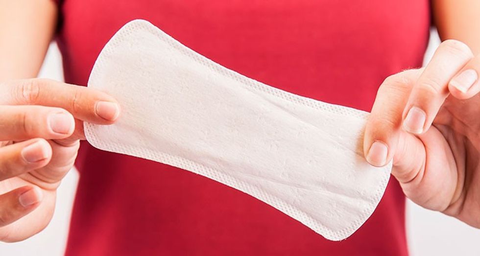 woman holding pad for period in her hands
