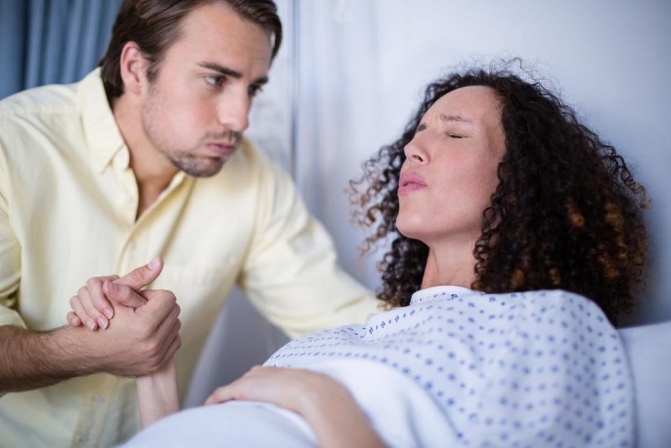 woman in labor holding partner s hand