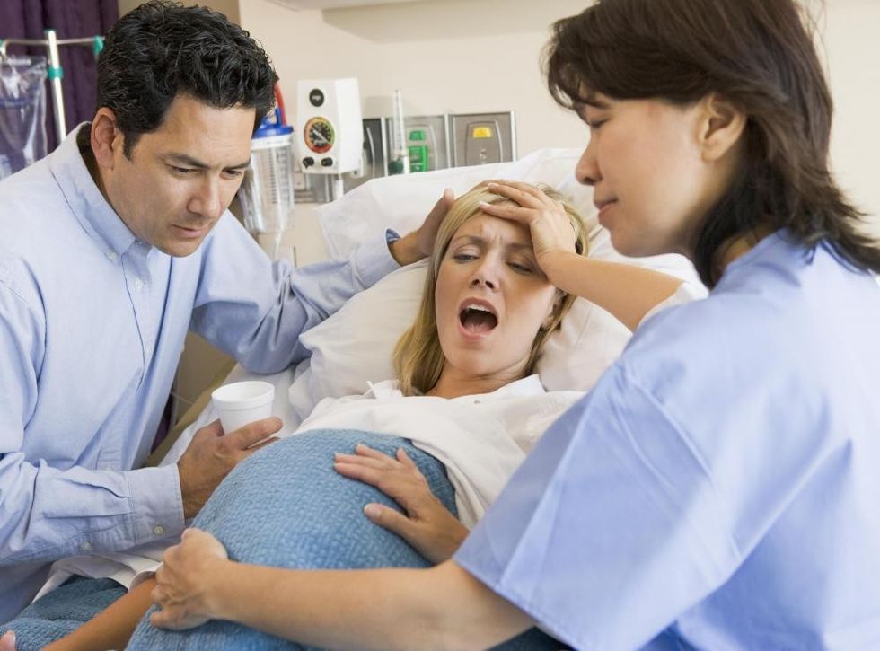 woman in labor with husband and female doctor