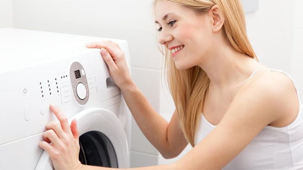 woman in white near washing machine