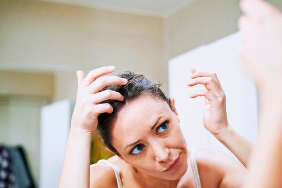 Woman looking in a mirror France