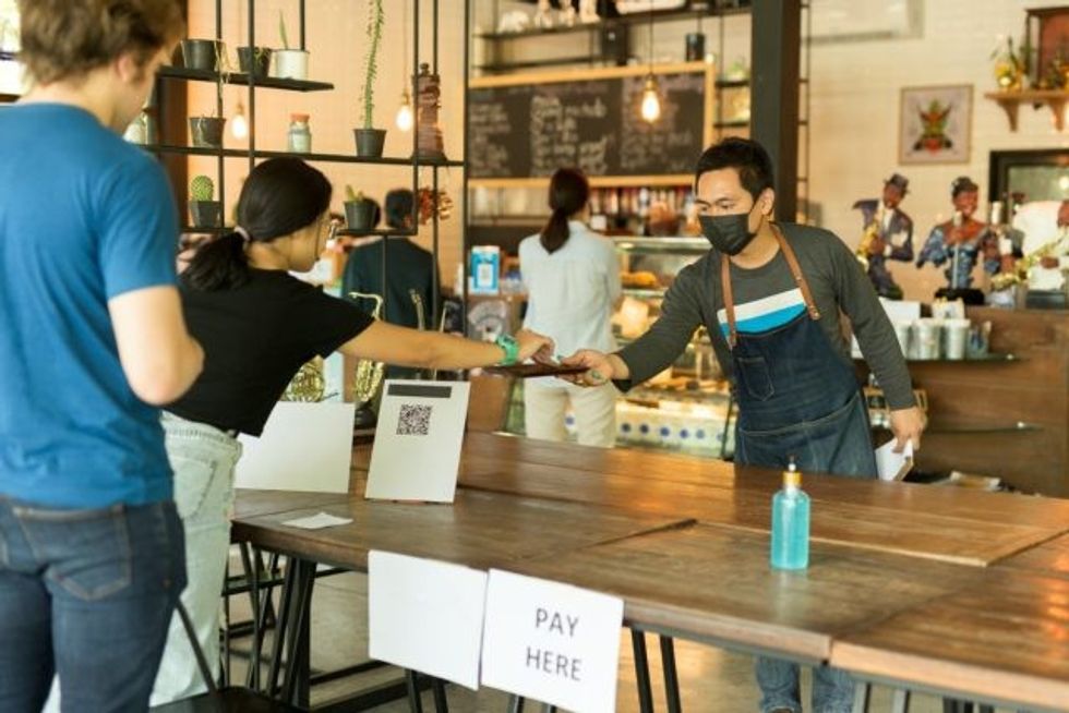 woman pay coffee shop cafe social distance