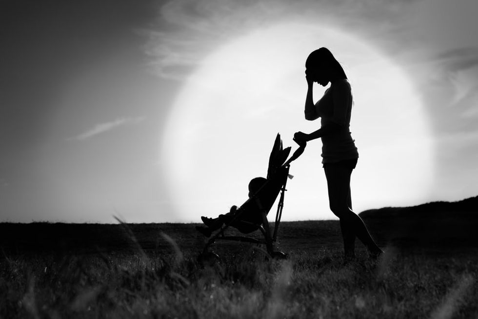 Woman Pushing Stroller Looking Unhappy