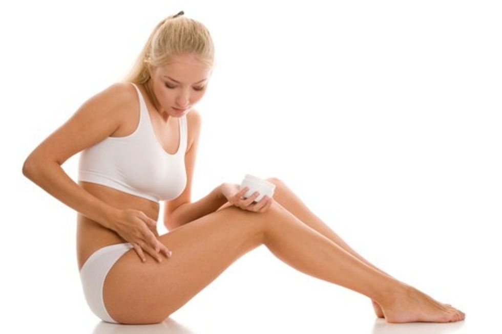woman putting lotion on