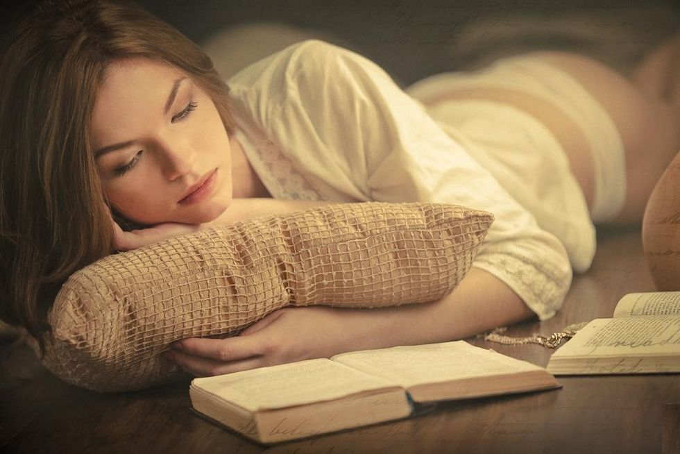 woman sleeping book