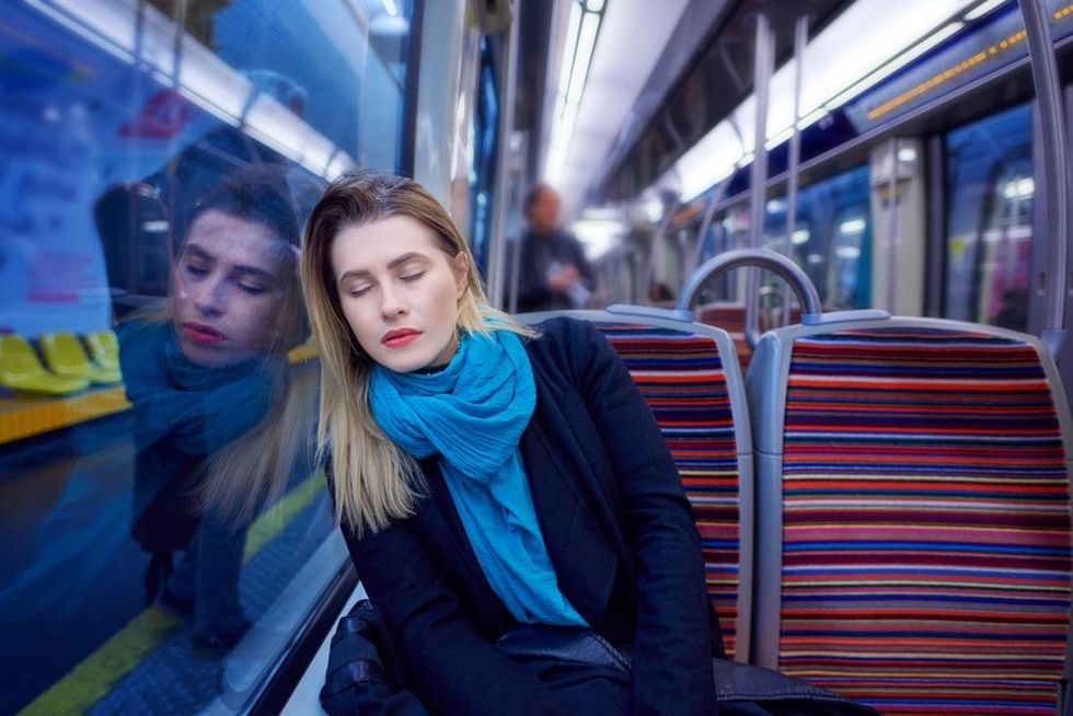 woman sleeping on train