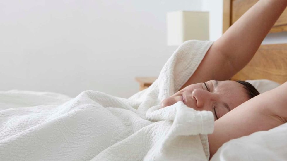 woman stretching in bed 1